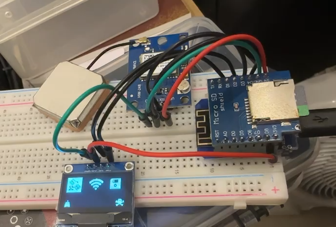 ESP8266 wardriver on a breadboard with the OLED showing GPS, Wi-Fi and SD icons