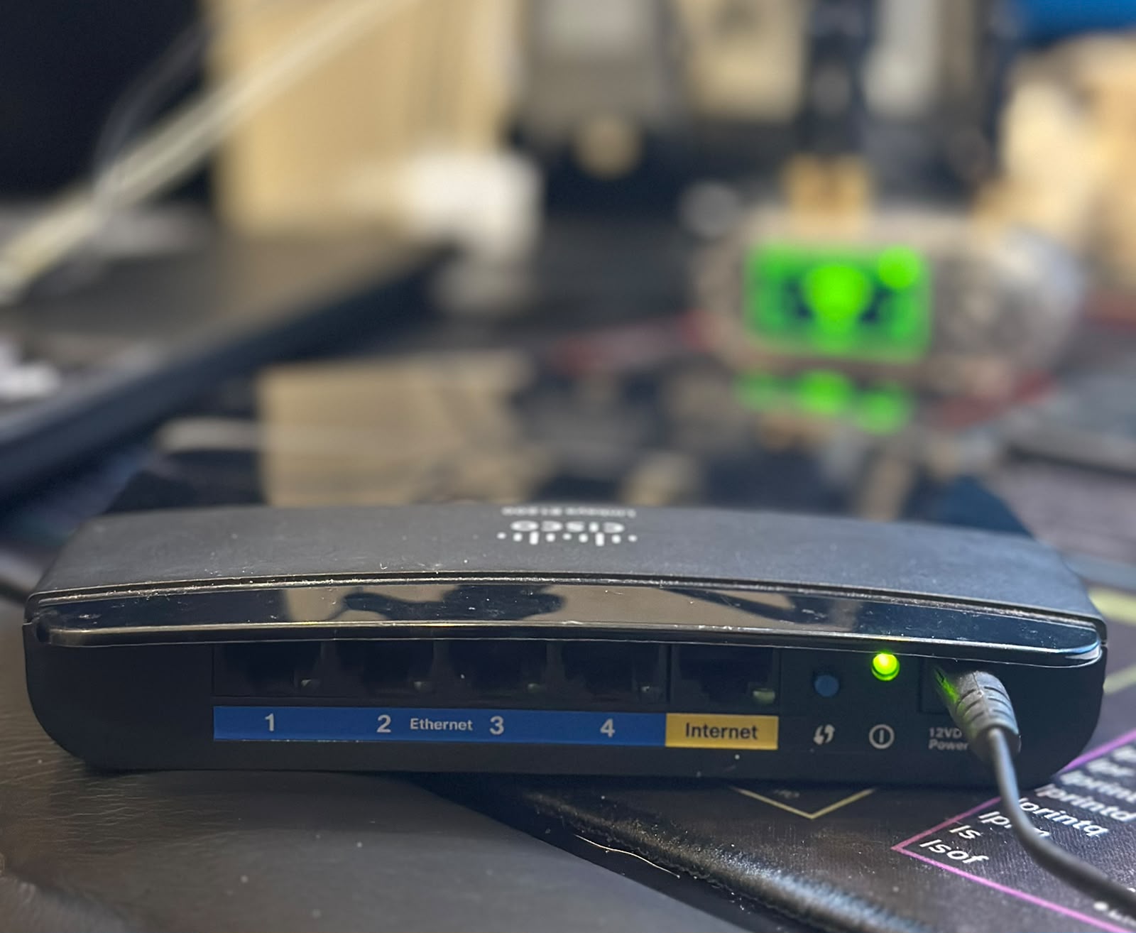 The old Linksys E1200 pressed into service as a test target
